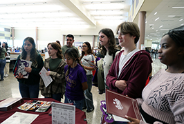  A group of students stand together listening
